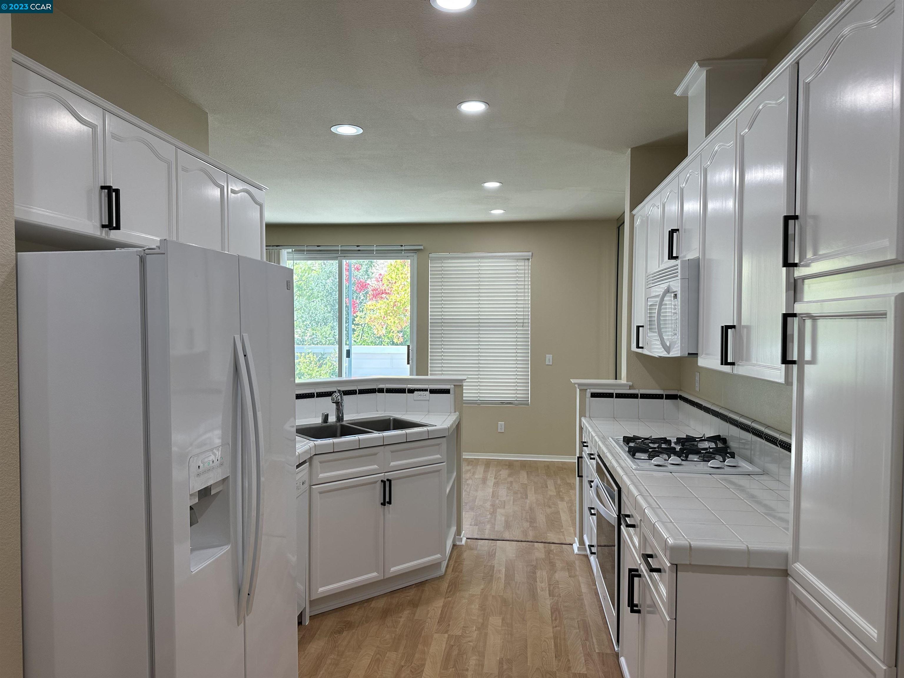 3505 Coyote Circle Clayton, CA 94517 - Photo 7 of 16 a kitchen with stainless steel appliances a refrigerator sink and stove