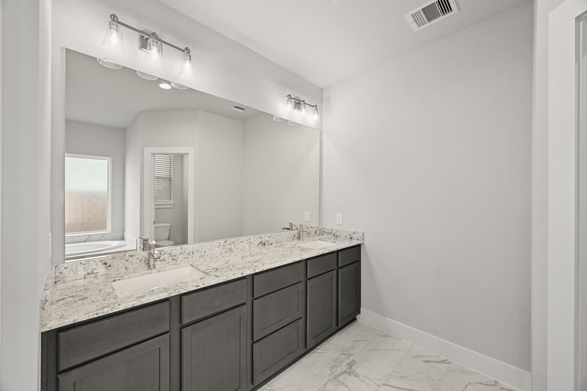 3308 Pin Cherry Lane Conroe, TX 77301 - Photo 16 of 45 a bathroom with a granite countertop sink double and mirror