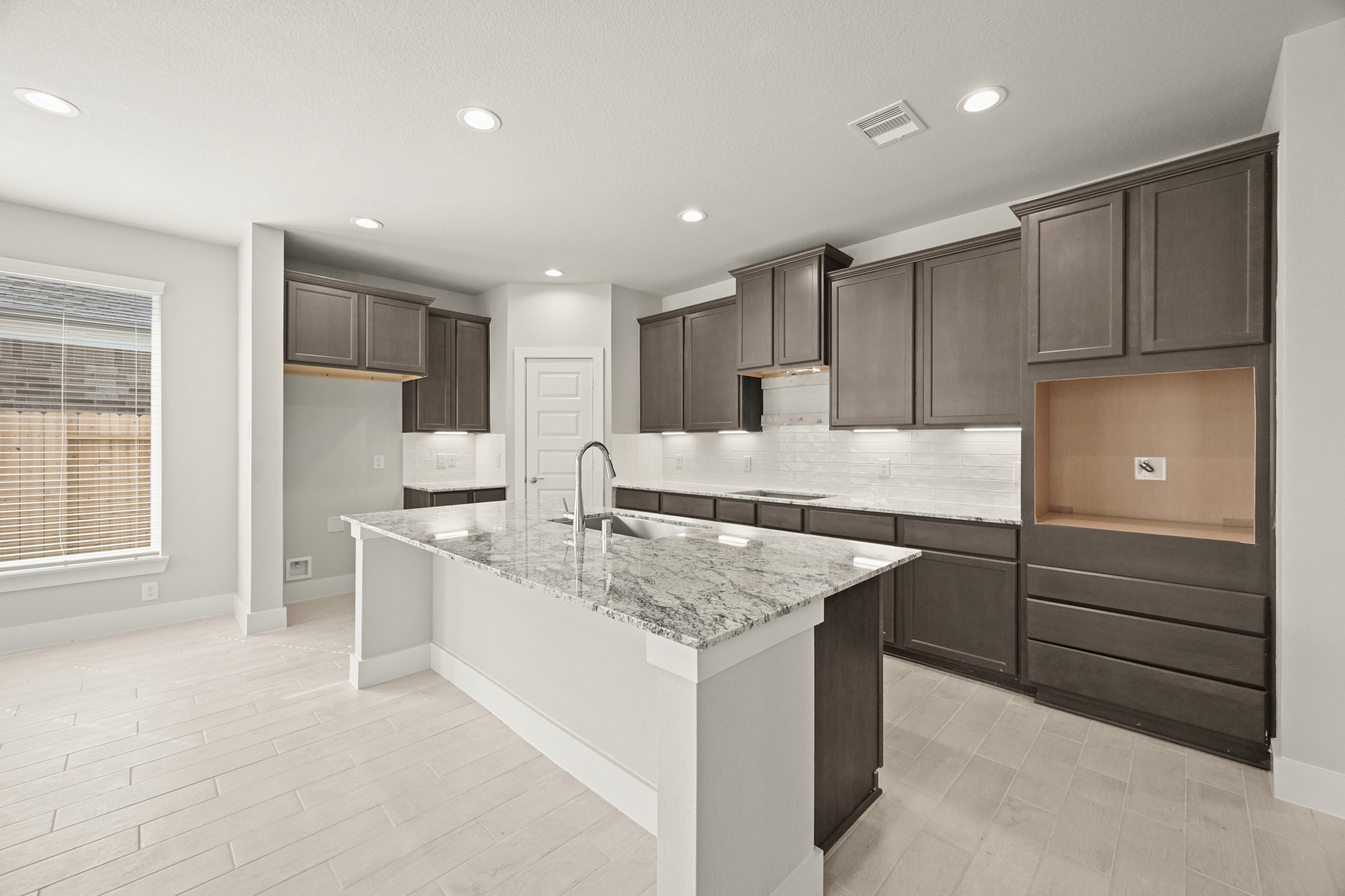 3308 Pin Cherry Lane Conroe, TX 77301 - Photo 3 of 45 a kitchen with kitchen island cabinets and refrigerator
