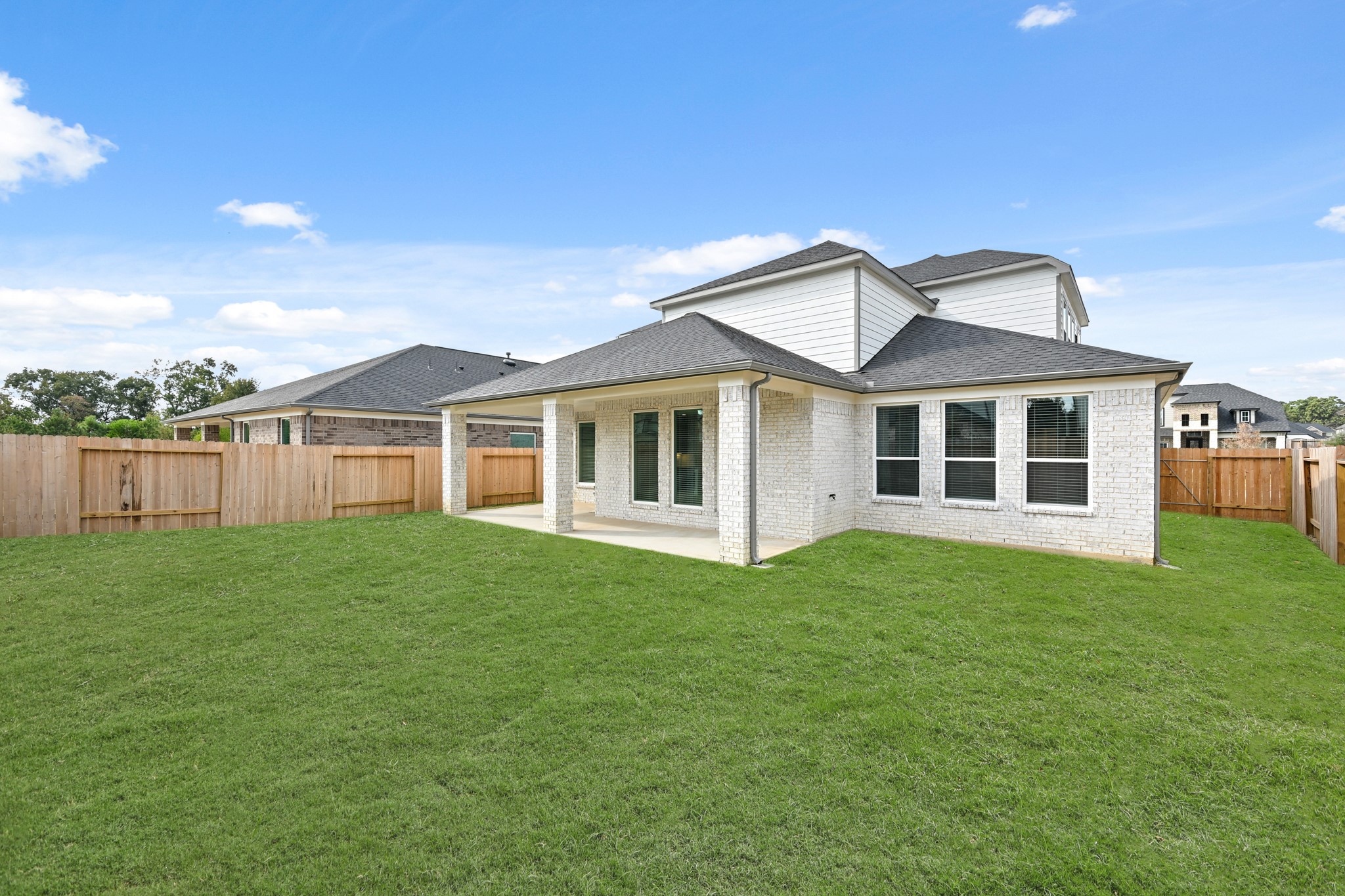 3308 Pin Cherry Lane Conroe, TX 77301 - Photo 39 of 45 a view of a big house with a big yard and large trees