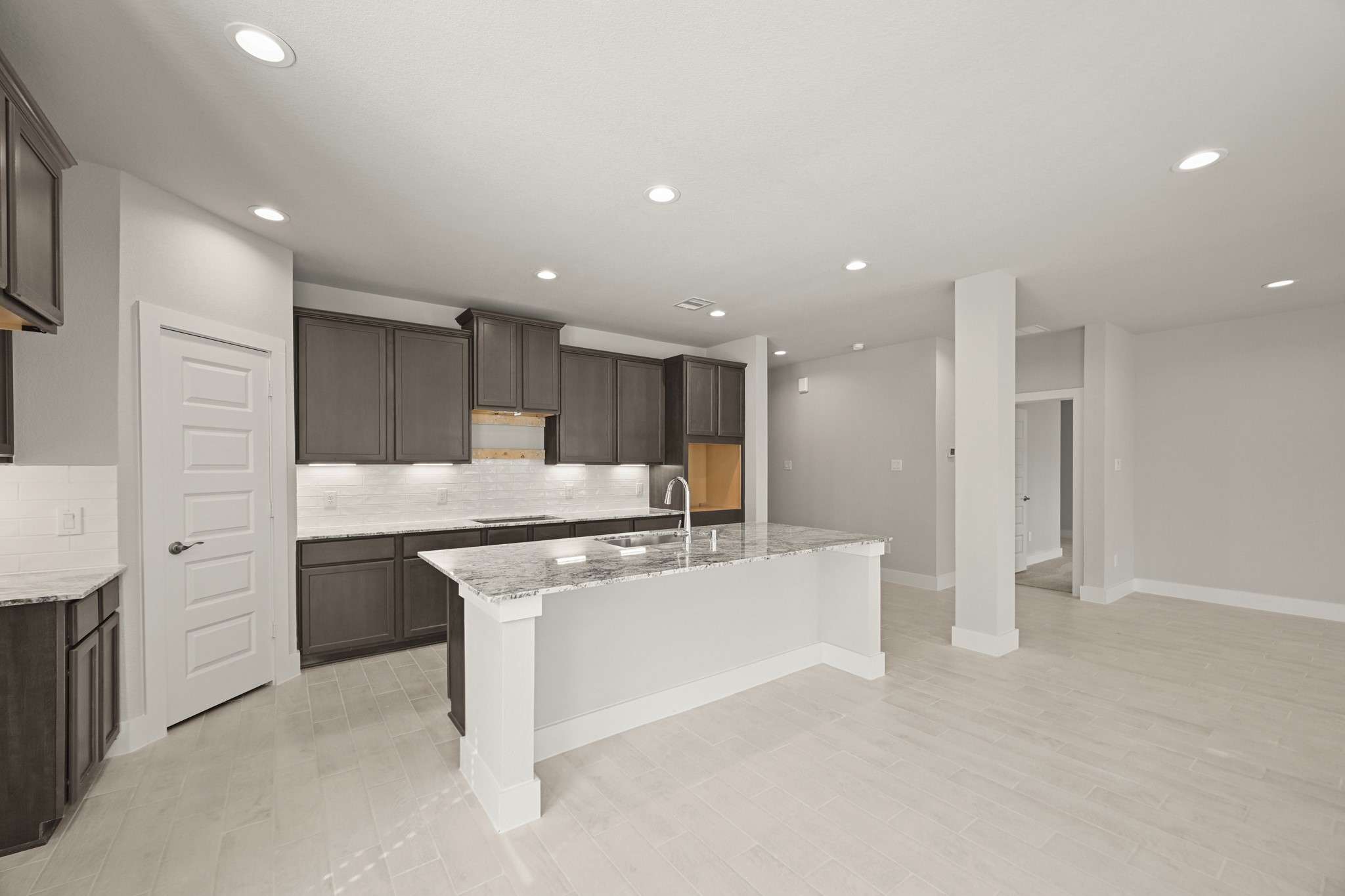 3308 Pin Cherry Lane Conroe, TX 77301 - Photo 5 of 45 a large white kitchen with stainless steel appliances granite countertop a stove a sink a refrigerator and white cabinets