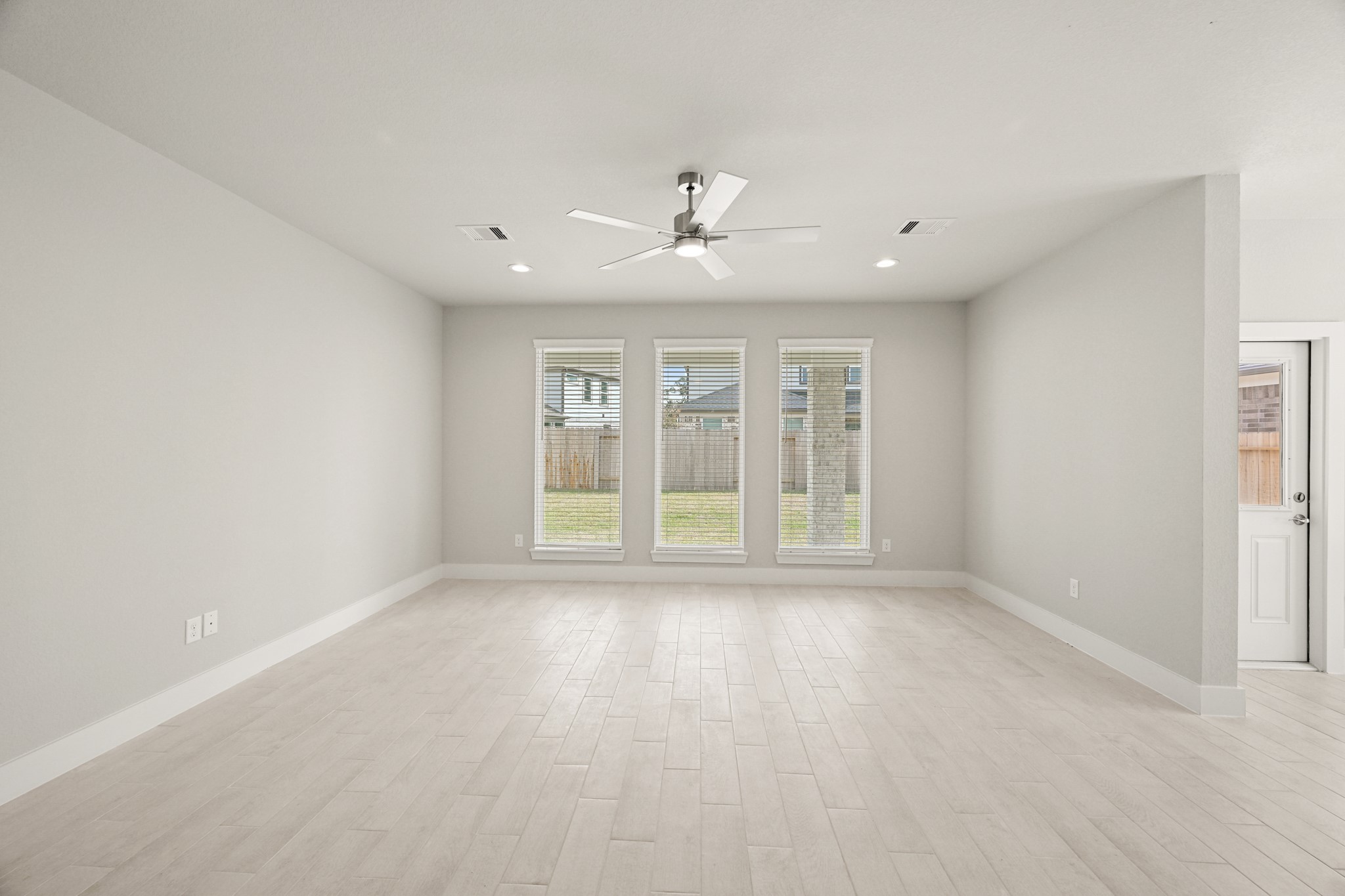 3308 Pin Cherry Lane Conroe, TX 77301 - Photo 8 of 45 wooden floor in an empty room with a window