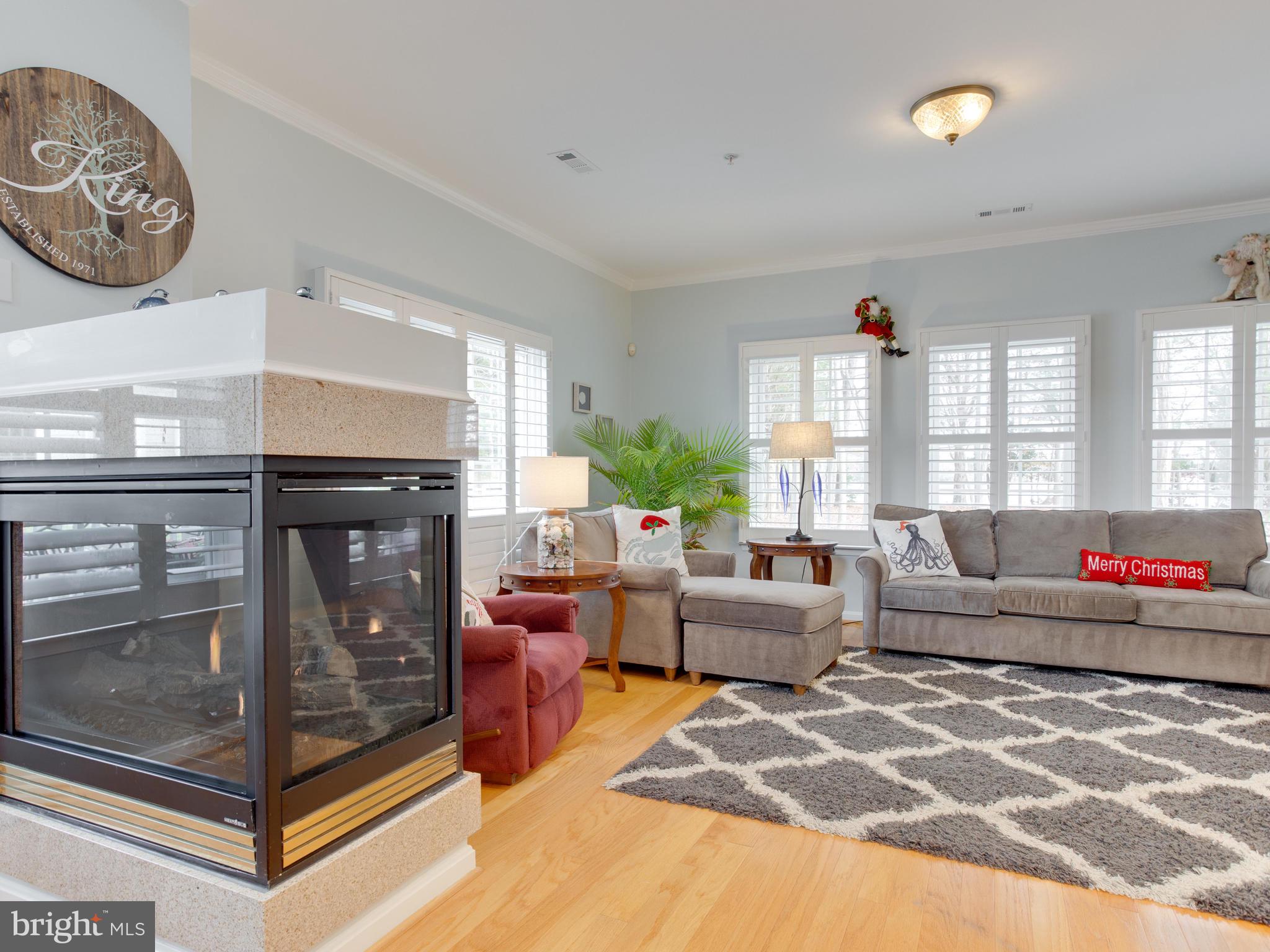 700 Ruxton Road, Unit 71 Solomons, MD 20629 - Photo 22 of 66 Fireplace between living room and dining room