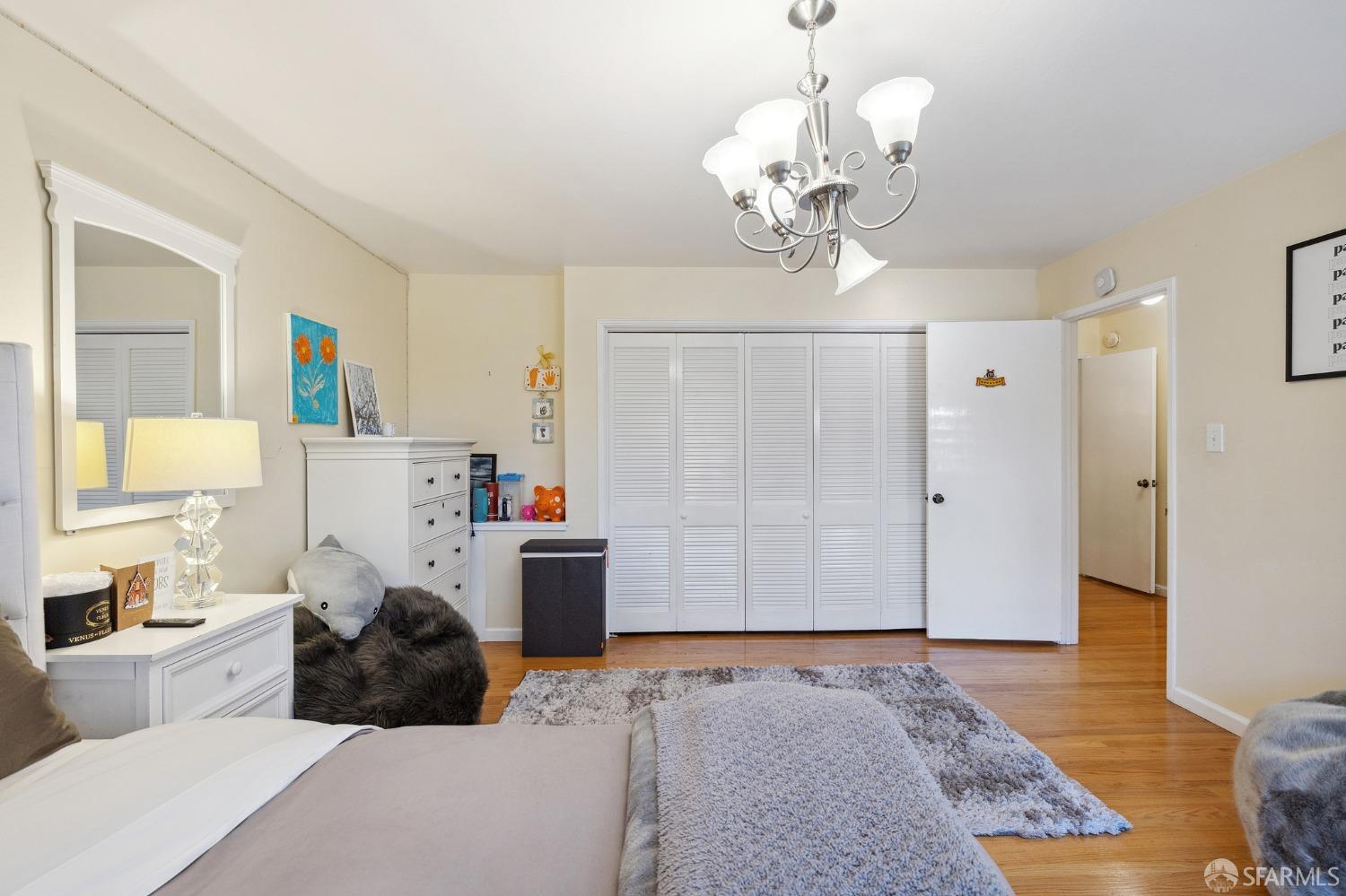 57 Ridge View Drive Atherton, CA 94027 - Photo 21 of 33 a bedroom with a bed and a chandelier