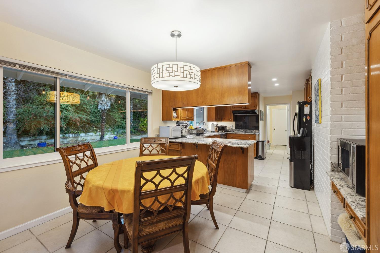 57 Ridge View Drive Atherton, CA 94027 - Photo 31 of 33 a dining room with furniture a chandelier and fireplace