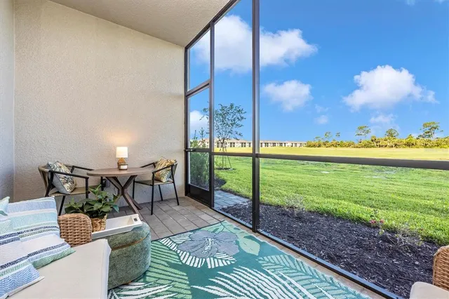 a building outdoor space with patio furniture and potted plants