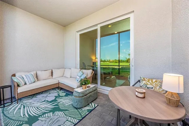 a swimming pool view with a seating space and a garden view