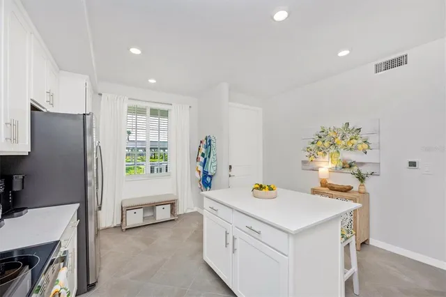 a living room with furniture a window and a flat screen tv