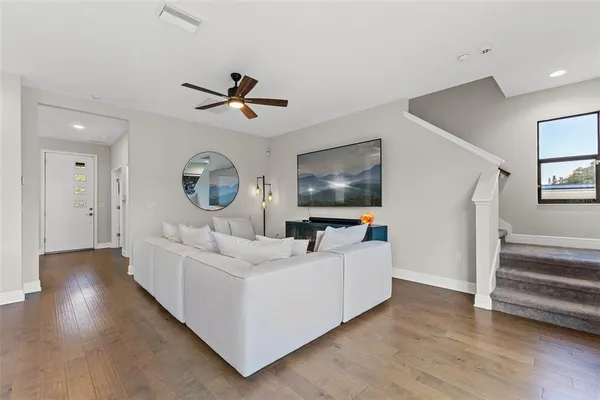 a living room with furniture and a flat screen tv