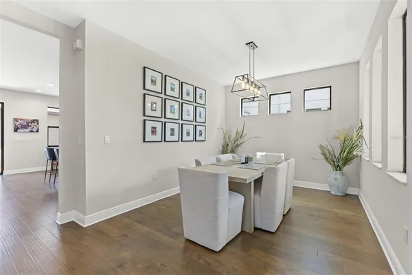 a view of a dining room with a table and chairs