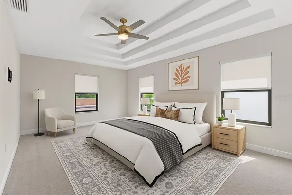 a bedroom with a large bed and a chandelier