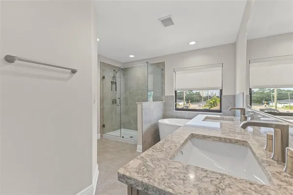 a large white room with a large window vanity and shower
