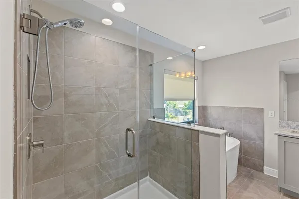 a bathroom with a shower and a window