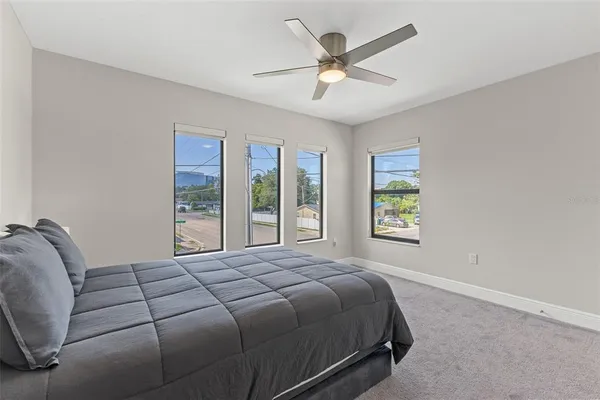 a bedroom with a large bed and a large window