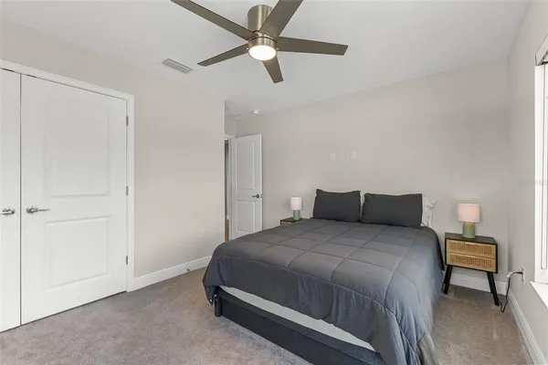 a bedroom with a bed and a chandelier