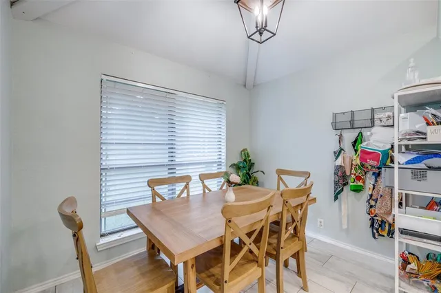 a view of a dining room with furniture and a chandelier