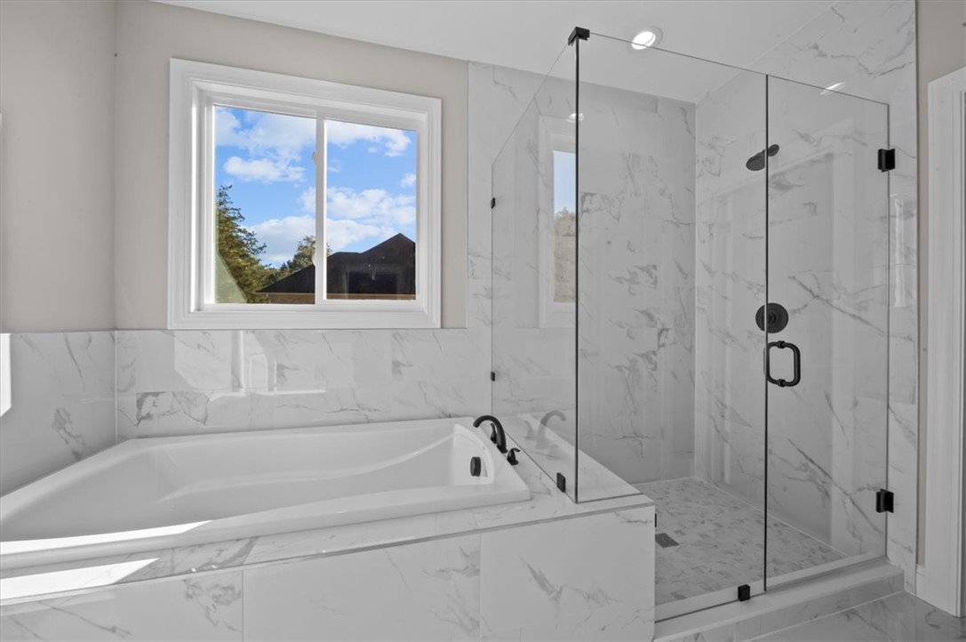 105 Bree Drive Anderson, SC 29621 - Photo 22 of 48 Indulge in a primary bathroom featuring a generous soaking tub and a spacious, clear glass shower enclosure.