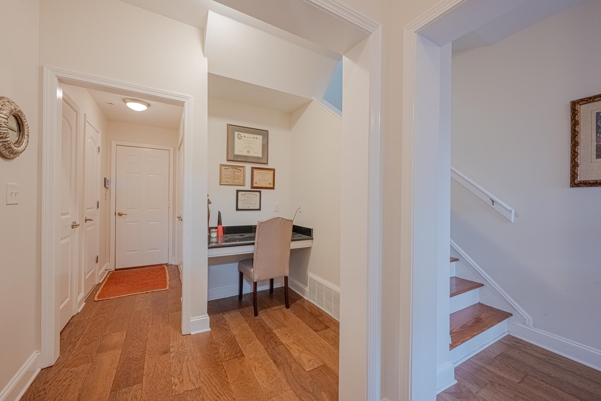 75 Shoemaker Court, Unit 105 Memphis, TN 38103 - Photo 13 of 25 a view of a hallway with entryway wooden floor and front door