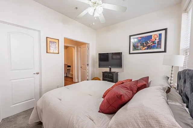 a bedroom with a bed and a flat screen tv