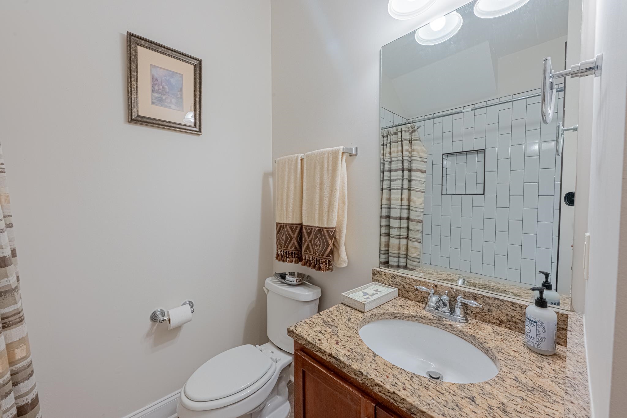 75 Shoemaker Court, Unit 105 Memphis, TN 38103 - Photo 16 of 25 a bathroom with a granite countertop sink toilet and shower