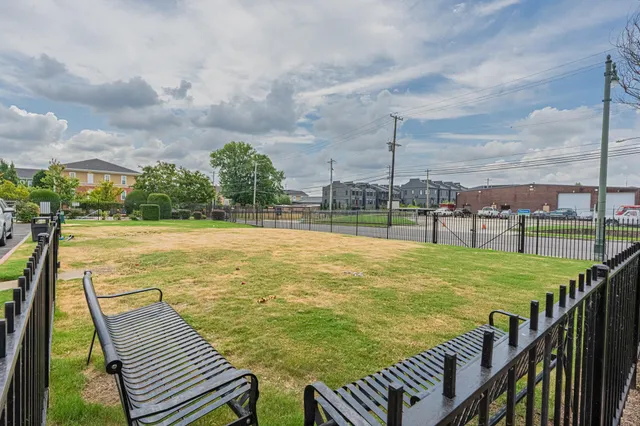 a view of a house with a yard and sitting area