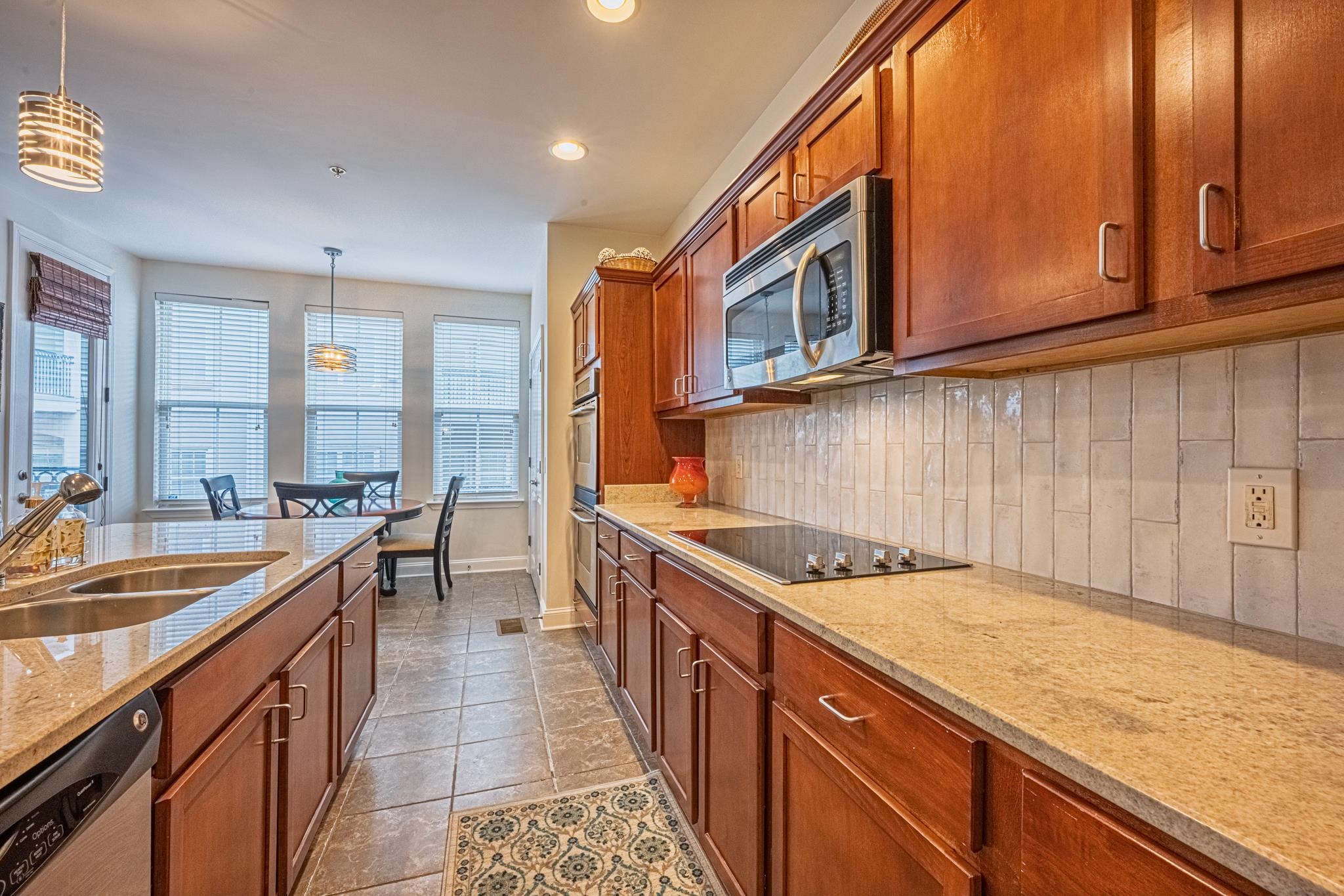75 Shoemaker Court, Unit 105 Memphis, TN 38103 - Photo 7 of 25 a kitchen with stainless steel appliances granite countertop a sink and cabinets