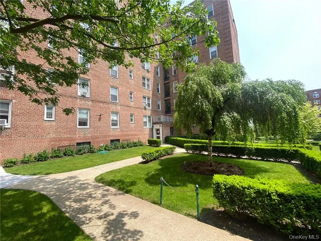 a view of a brick building next to a yard
