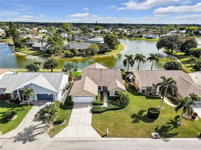 an aerial view of residential houses with outdoor space and river
