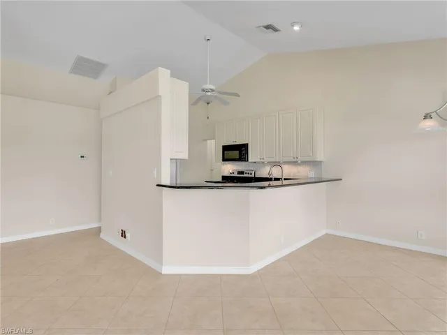 a view of kitchen cabinets and stainless steel appliances