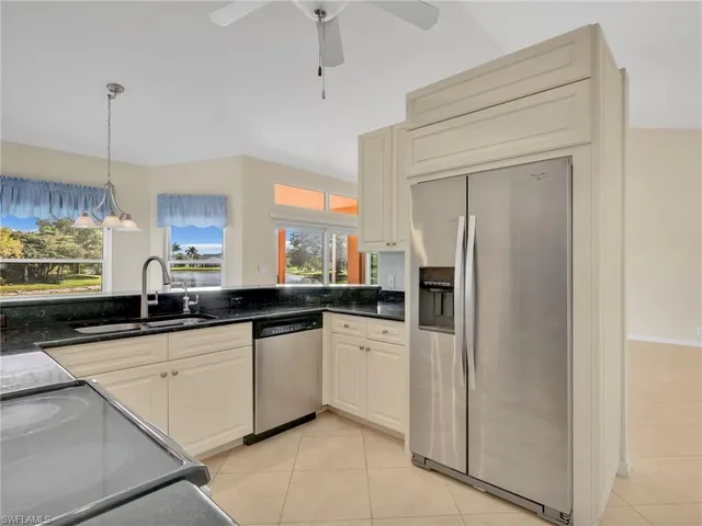 a kitchen with granite countertop a sink and cabinets