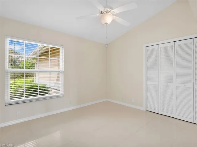 an empty room with a chandelier fan
