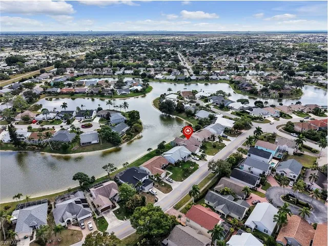 an aerial view of a house with a lake view