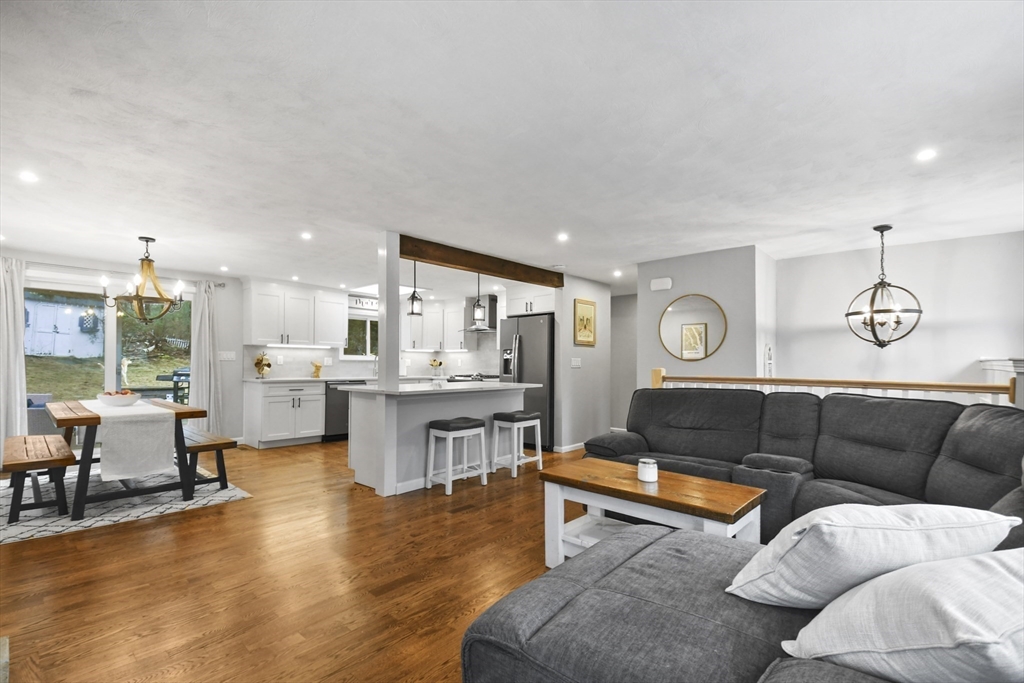 14 Town Line Road Burlington, MA 01803 - Photo 8 of 31 a living room with furniture kitchen view and a wooden floor