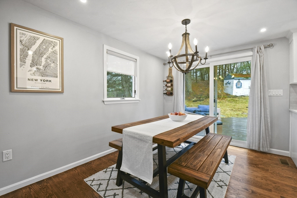 14 Town Line Road Burlington, MA 01803 - Photo 9 of 31 a dining room with wooden floor a chandelier a wooden table and chairs