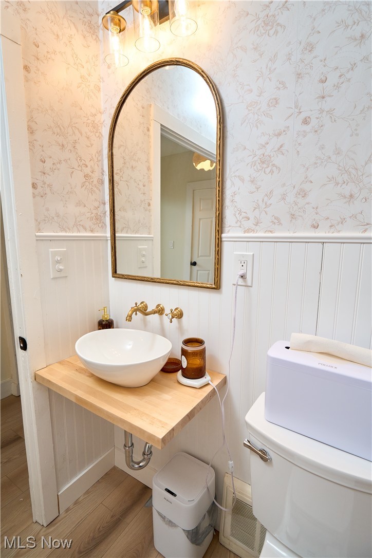 5432 State Road Parma, OH 44134 - Photo 14 of 47 Bathroom featuring light wood finished floors, vanity, and wallpapered walls