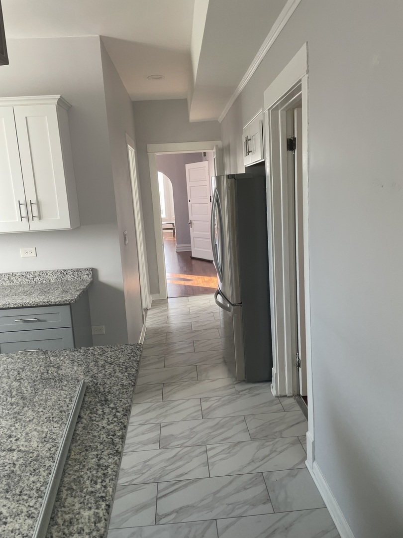 1511 North Keystone Avenue, Unit 2 Chicago, IL 60651 - Photo 6 of 8 a bathroom with a sink and a large mirror