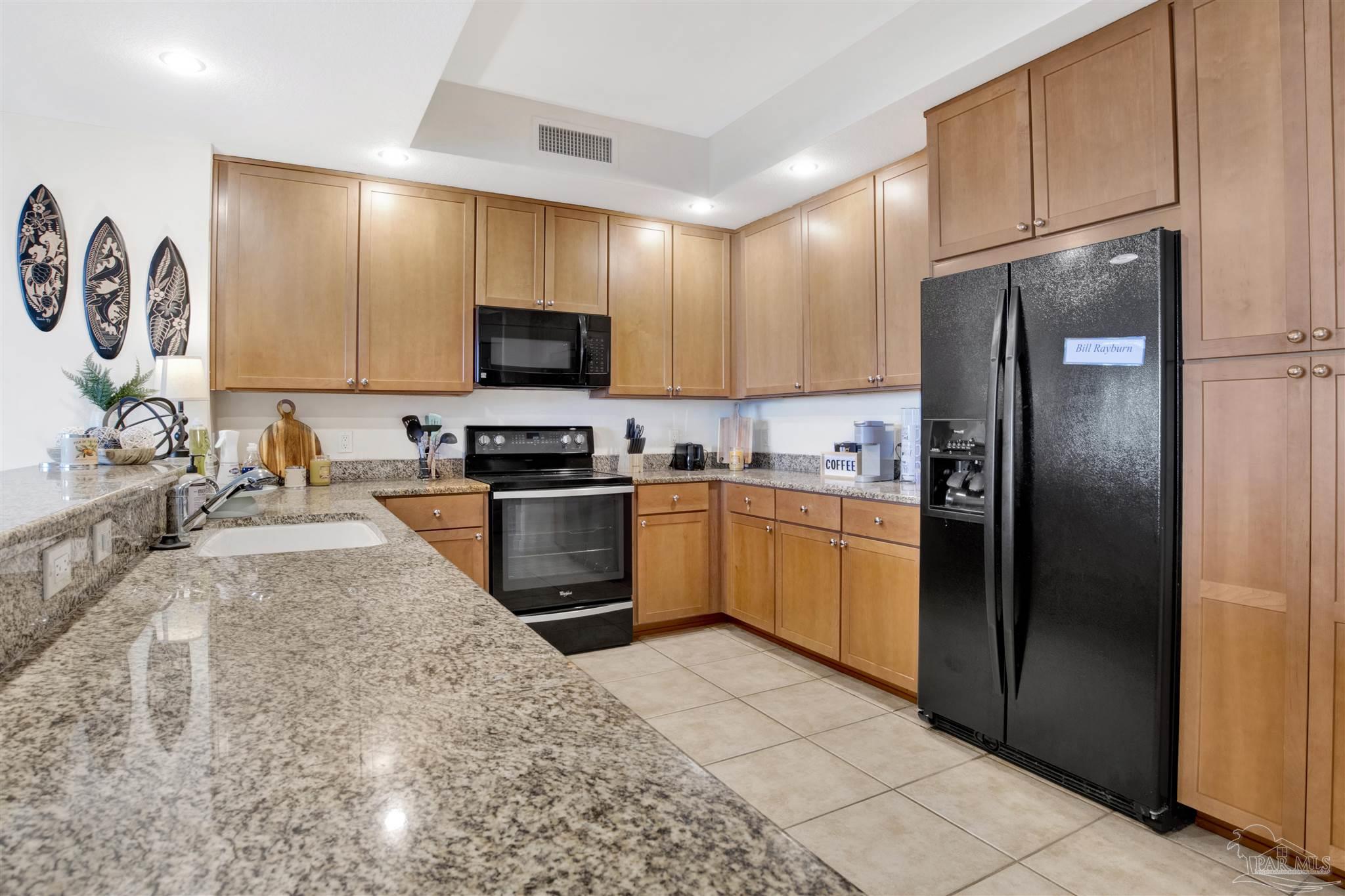 645 Lost Key Drive, Unit 704 Perdido Key, FL 32507 - Photo 11 of 31 a kitchen with granite countertop a refrigerator and a sink