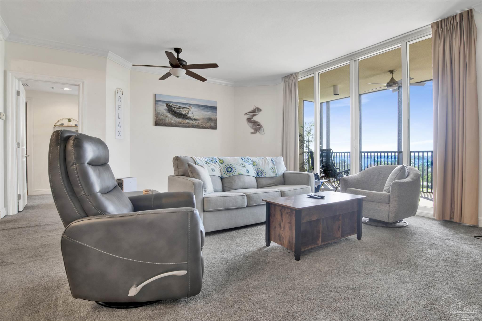 645 Lost Key Drive, Unit 704 Perdido Key, FL 32507 - Photo 13 of 31 a living room with couches and a dining table with wooden floor