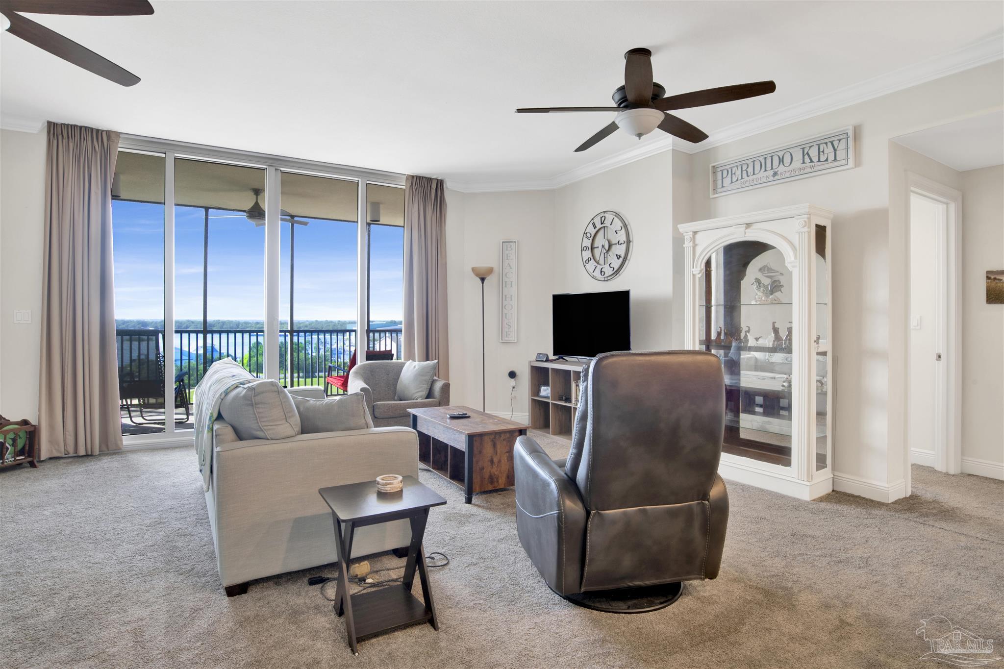 645 Lost Key Drive, Unit 704 Perdido Key, FL 32507 - Photo 14 of 31 a living room with furniture ceiling fan and a window