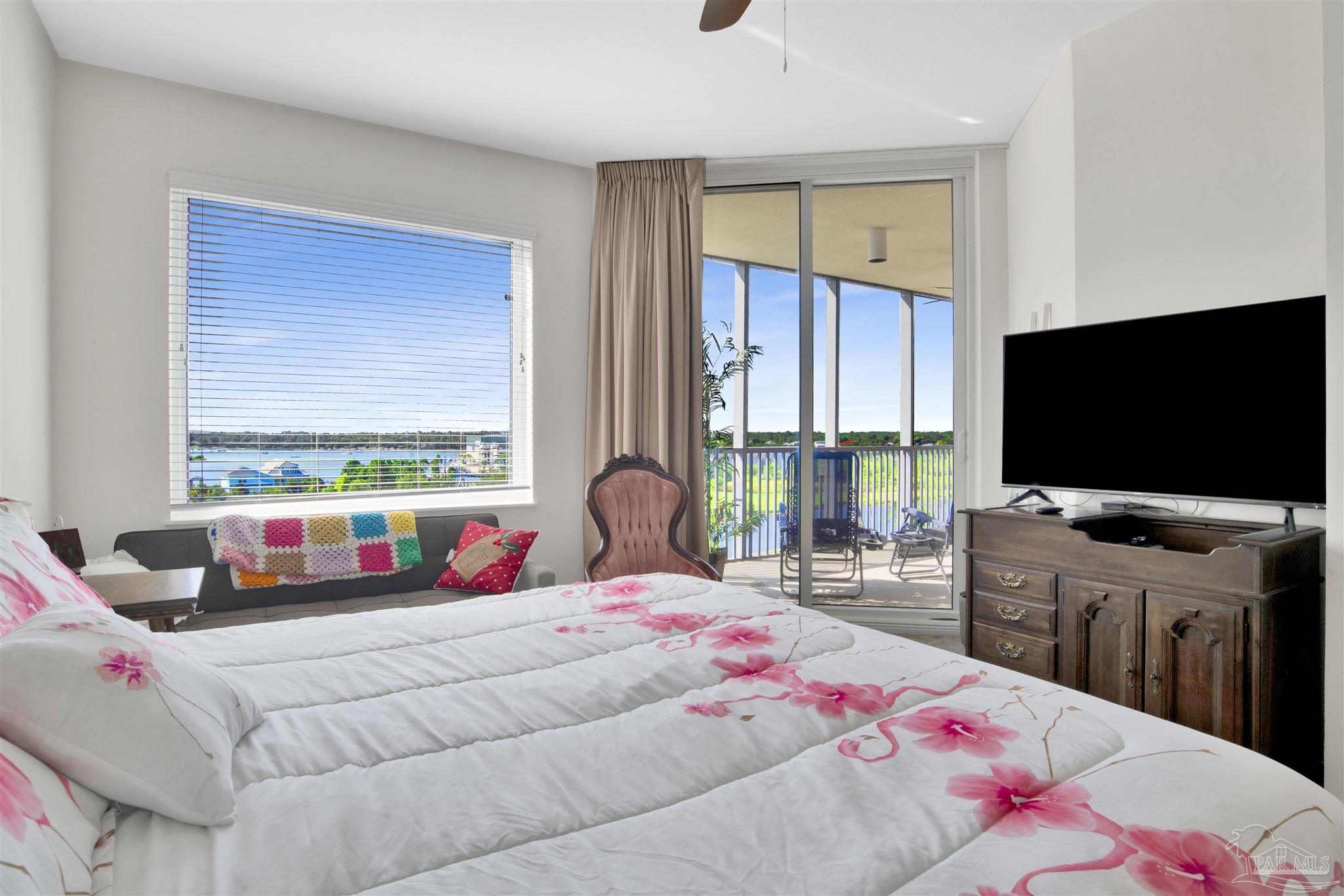 645 Lost Key Drive, Unit 704 Perdido Key, FL 32507 - Photo 17 of 31 a bedroom with a bed and large windows