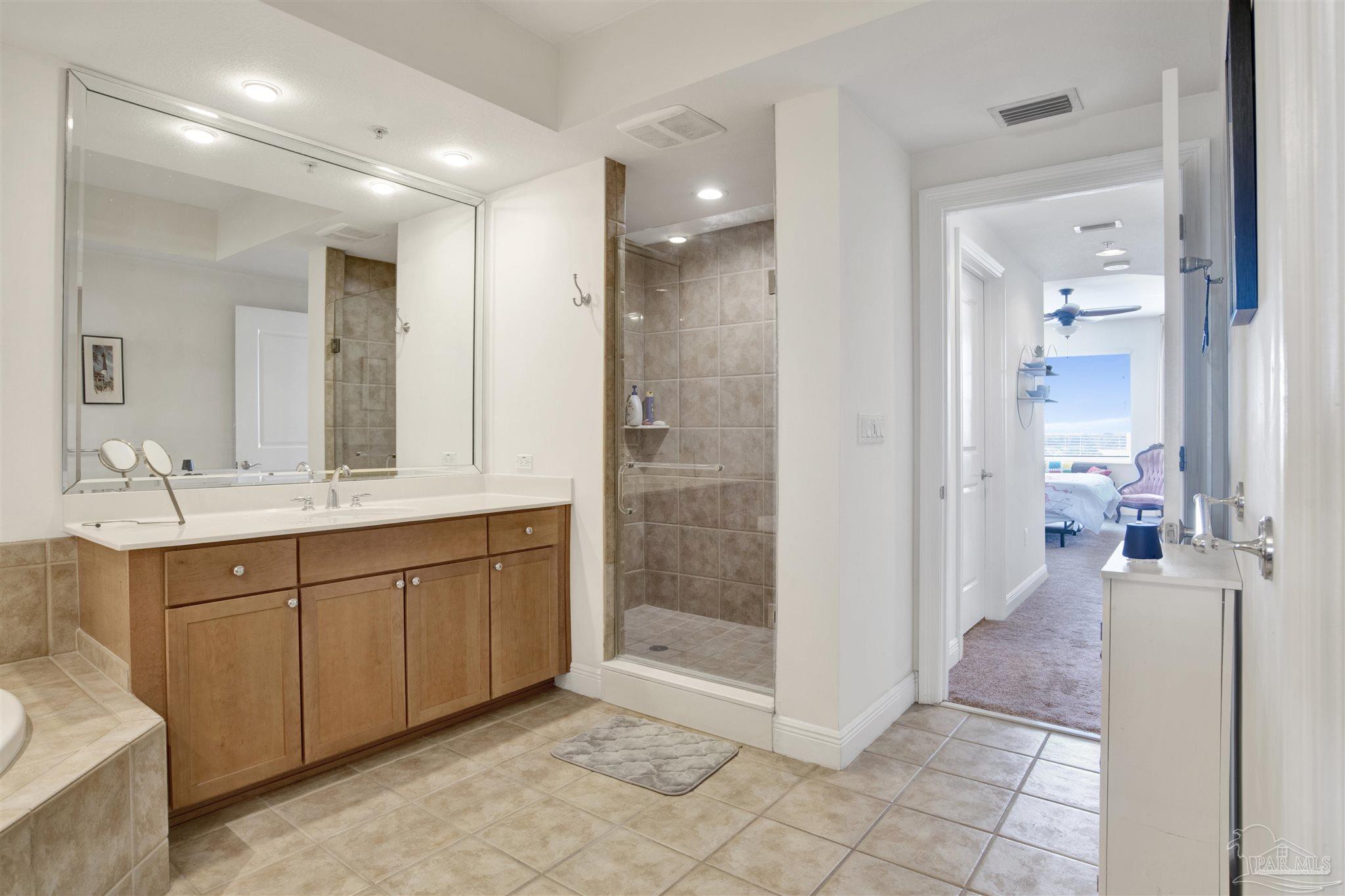 645 Lost Key Drive, Unit 704 Perdido Key, FL 32507 - Photo 19 of 31 a spacious bathroom with a mirror sink and shower