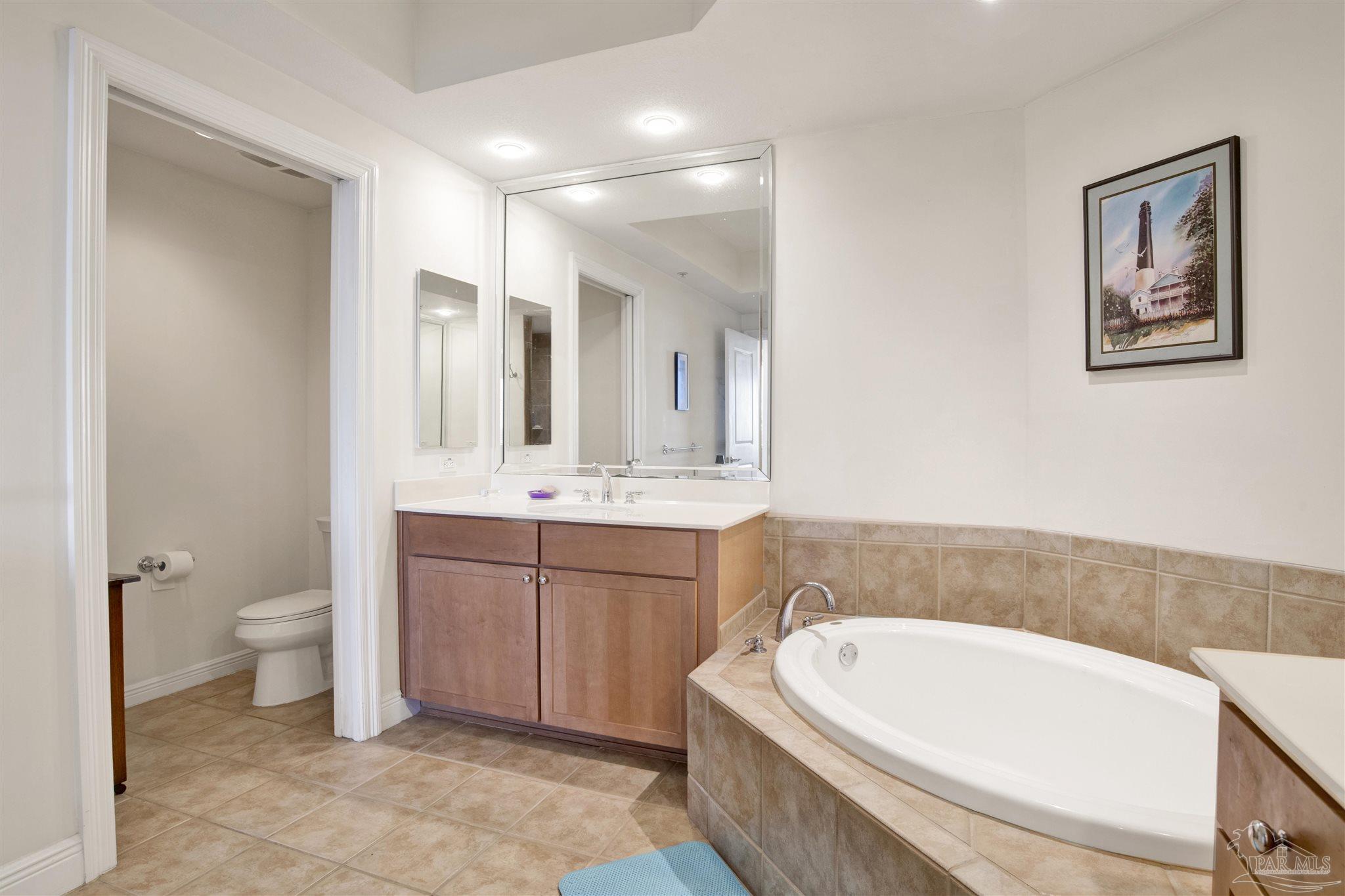 645 Lost Key Drive, Unit 704 Perdido Key, FL 32507 - Photo 20 of 31 a bathroom with a bathtub a sink and a toilet