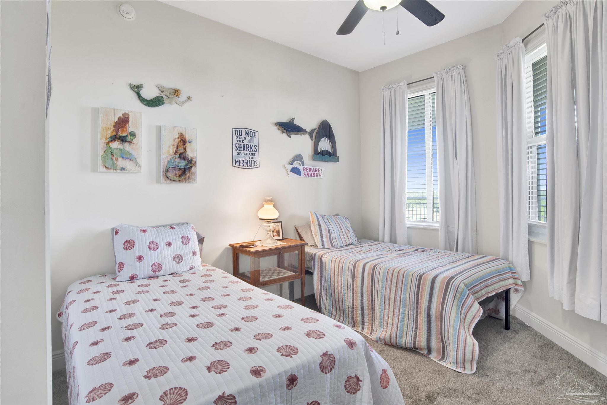 645 Lost Key Drive, Unit 704 Perdido Key, FL 32507 - Photo 21 of 31 a bedroom with two beds and a chandelier