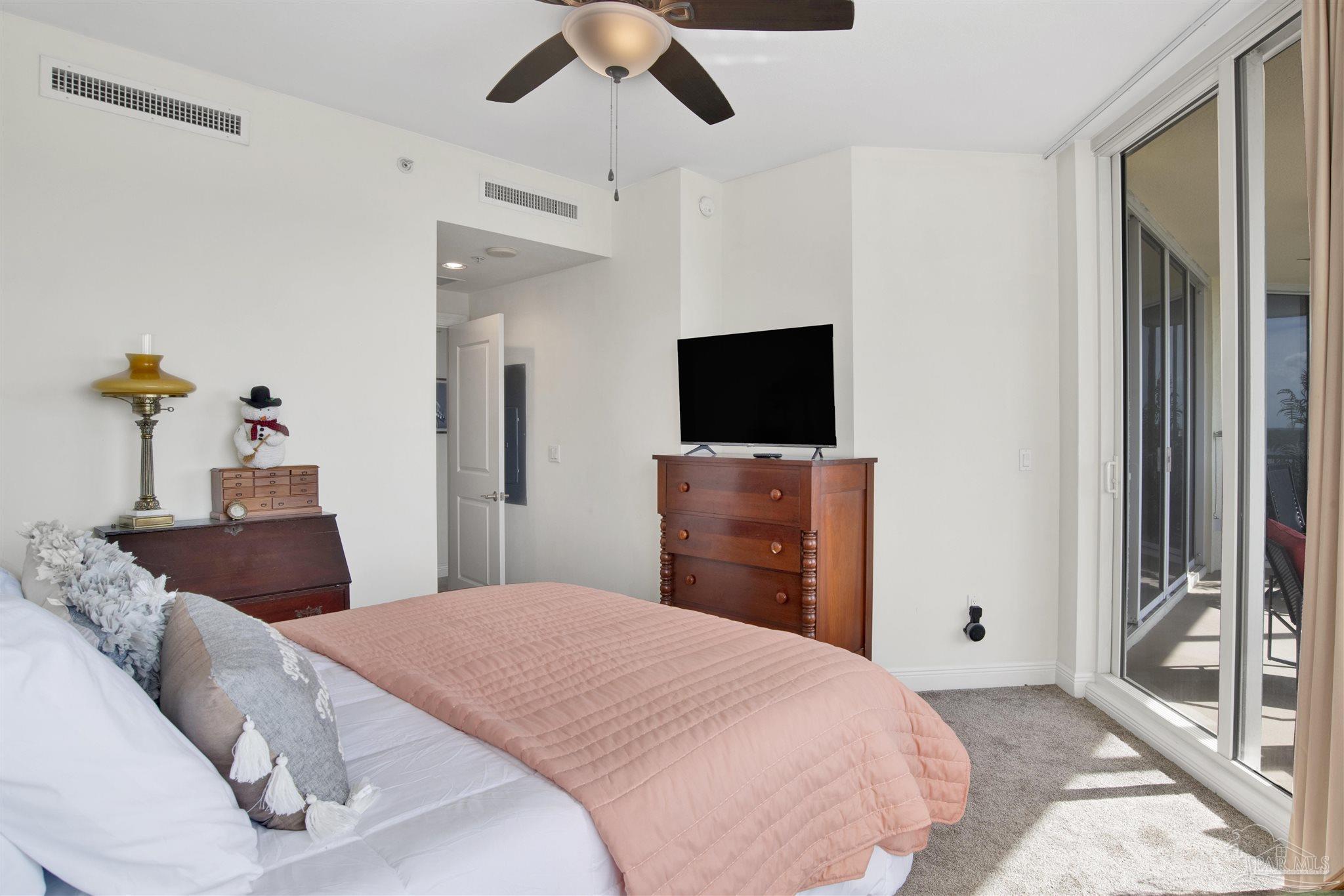 645 Lost Key Drive, Unit 704 Perdido Key, FL 32507 - Photo 24 of 31 a bedroom with a bed and a flat tv screen