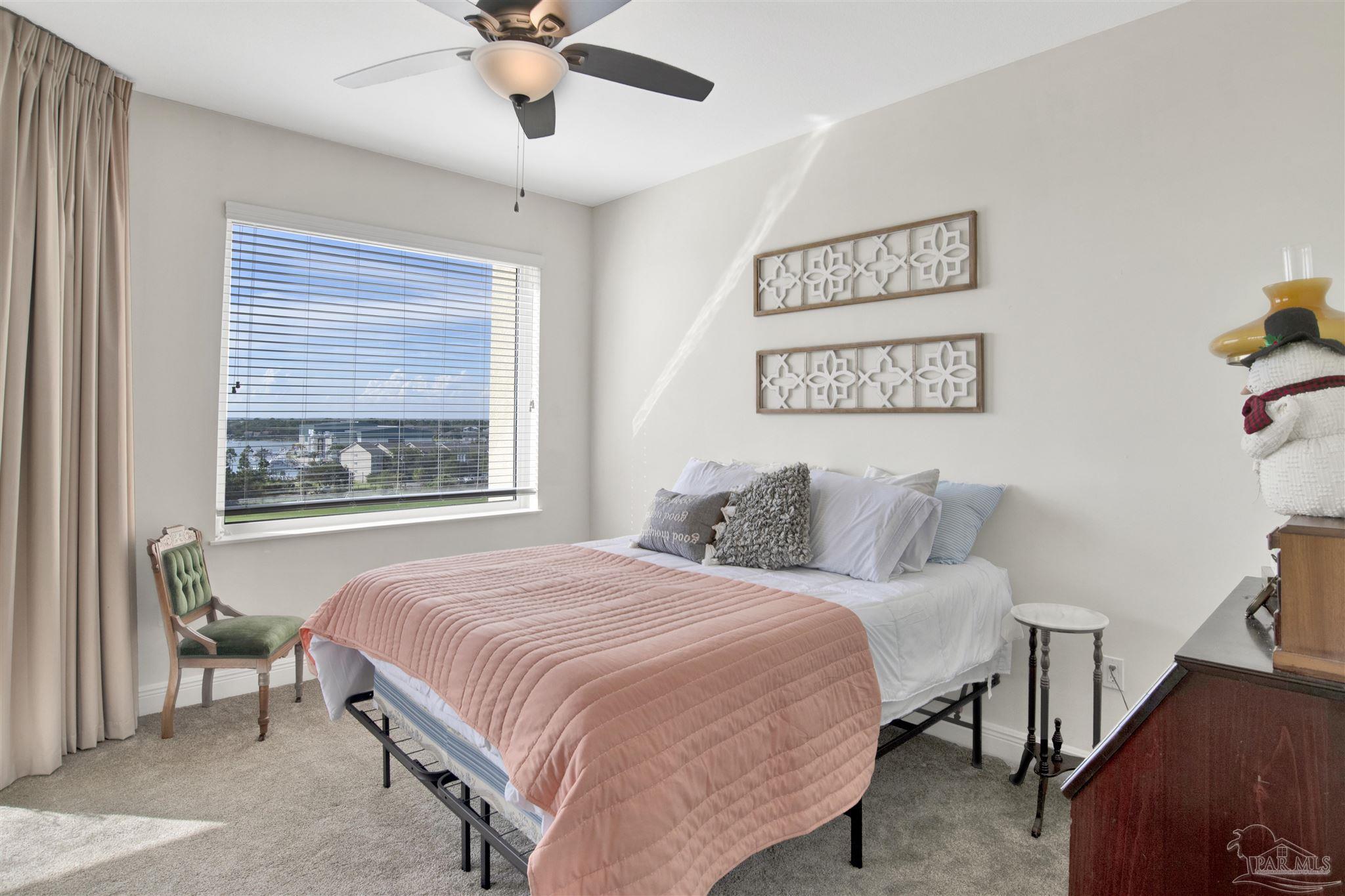 645 Lost Key Drive, Unit 704 Perdido Key, FL 32507 - Photo 25 of 31 a bedroom with a bed and a chandelier