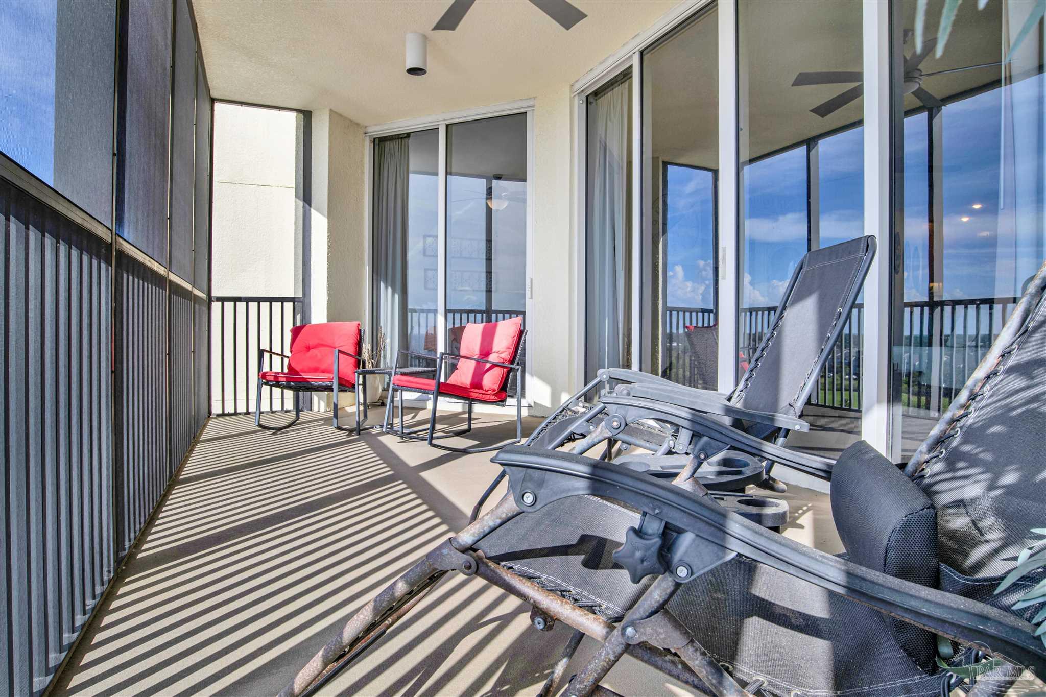 645 Lost Key Drive, Unit 704 Perdido Key, FL 32507 - Photo 26 of 31 a view of a deck with wooden floor and outdoor seating