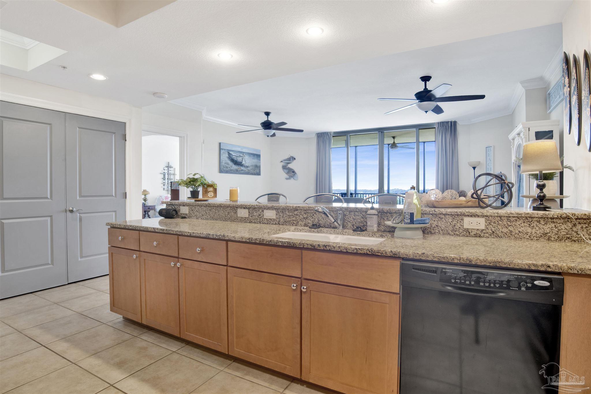 645 Lost Key Drive, Unit 704 Perdido Key, FL 32507 - Photo 8 of 31 a sink with granite countertop cabinets and a sink
