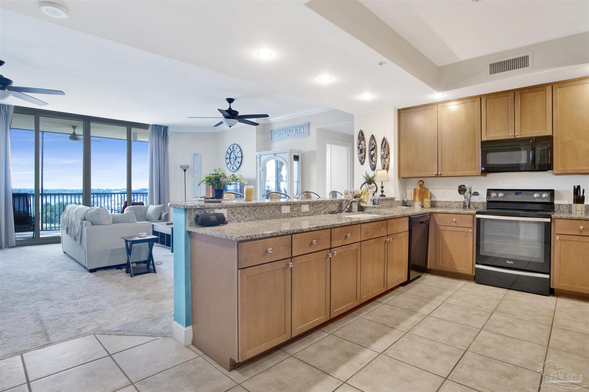 645 Lost Key Drive, Unit 704 Perdido Key, FL 32507 - Photo 9 of 31 a kitchen with stainless steel appliances kitchen island granite countertop a sink and cabinets