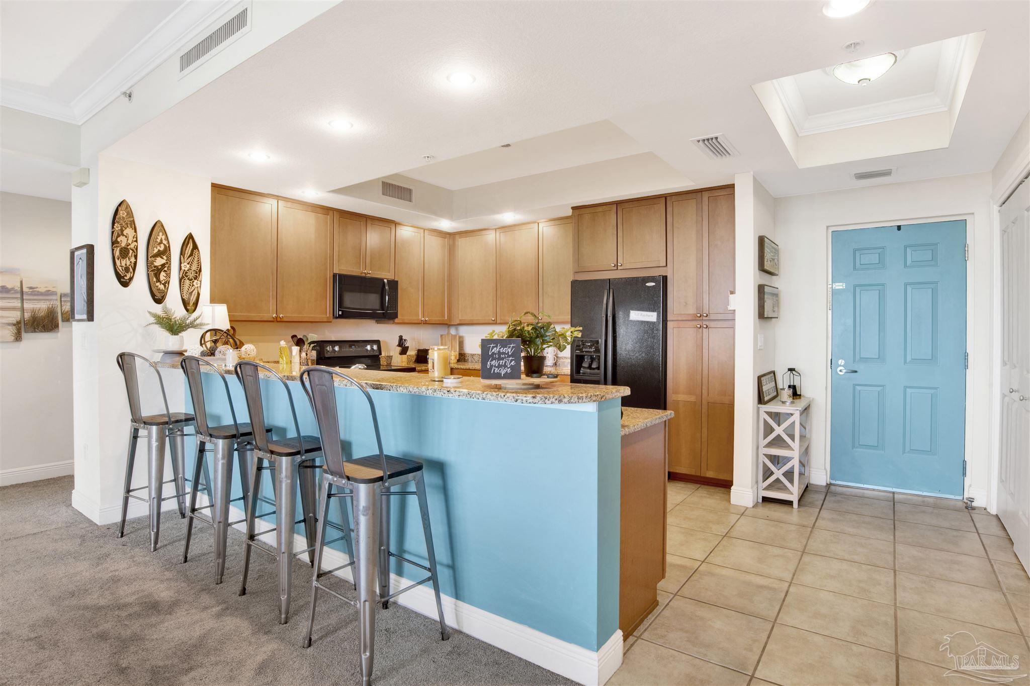 645 Lost Key Drive, Unit 704 Perdido Key, FL 32507 - Photo 10 of 31 a kitchen with stainless steel appliances a refrigerator and a stove top oven