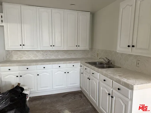 a kitchen with white cabinets